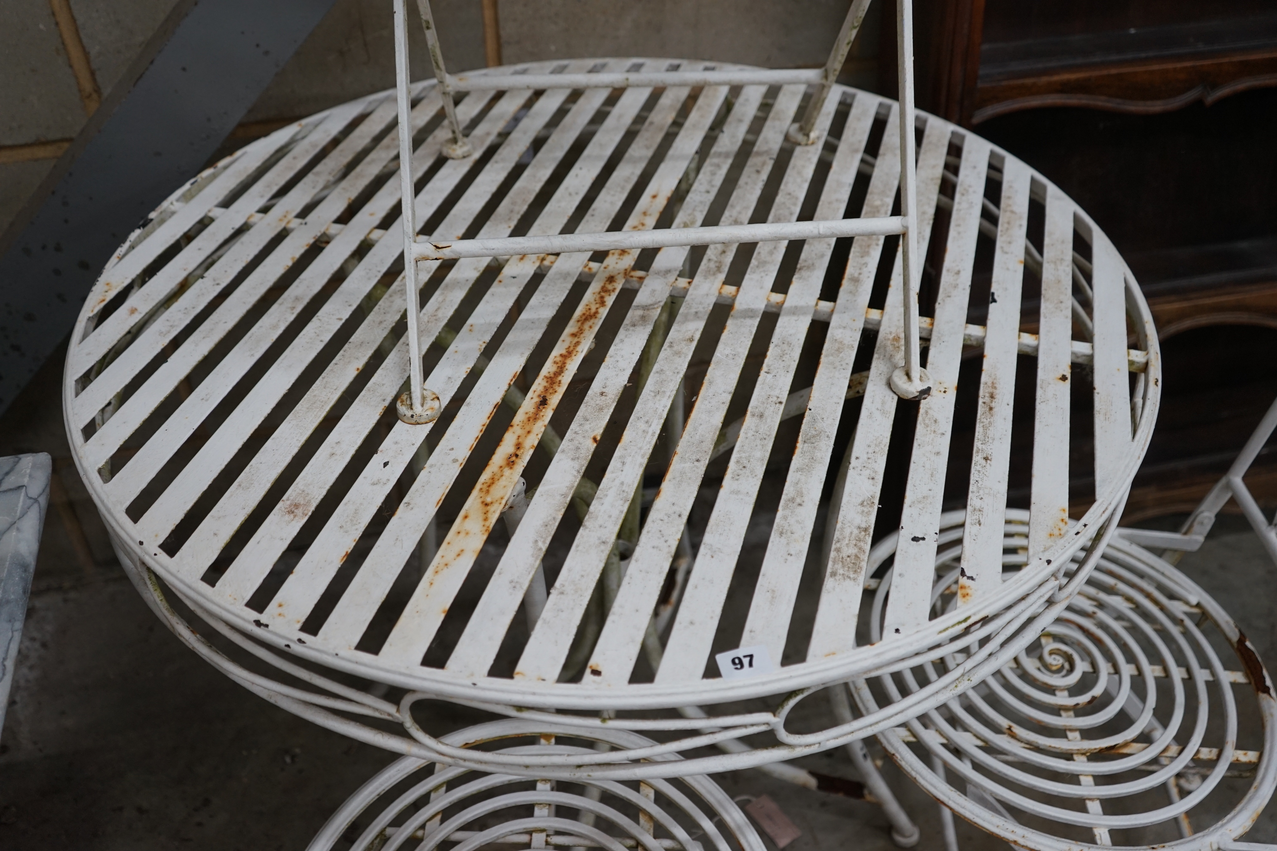 A circular metal garden table and three folding chairs, table diameter 90cm height 76cm